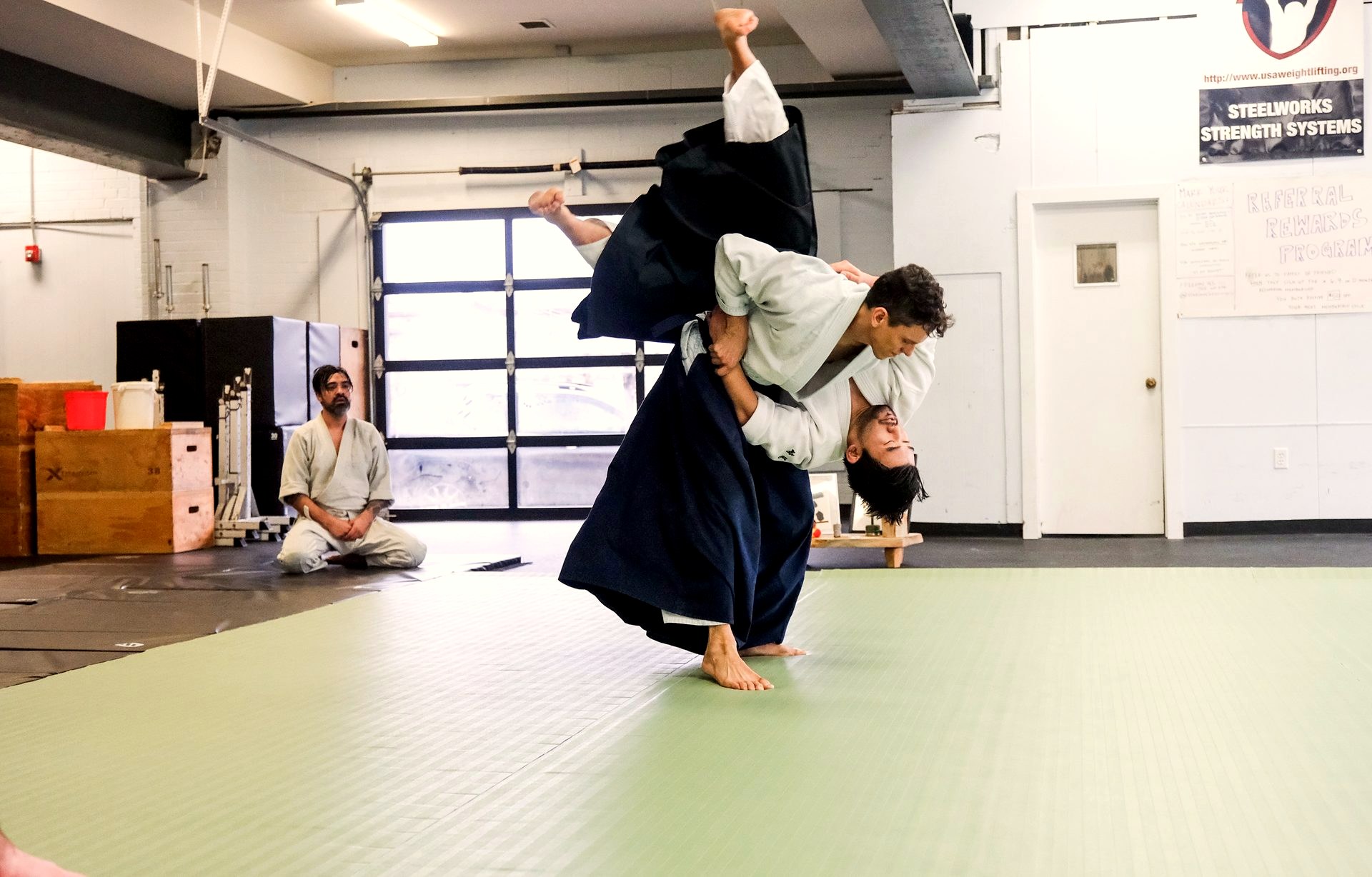 A high throw mid-air during aikido practice